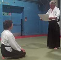 Foster Sensei presents a grading
                                certificate