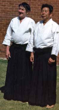 Foster Sensei of the Institute of
                                Aikido standing beside Saito Sensei of
                                the Iwama dojo