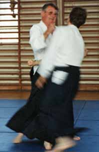 Foster Sensei at the Institute of
                                Aikido Summer School demonstrates atemi
                                during an Aikido technique.