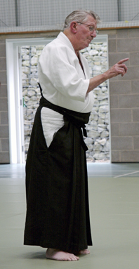 Aikido SMr Foster in the dojo at
                                the Institute of ummer Sdchool near
                                Bucknell standing pointing